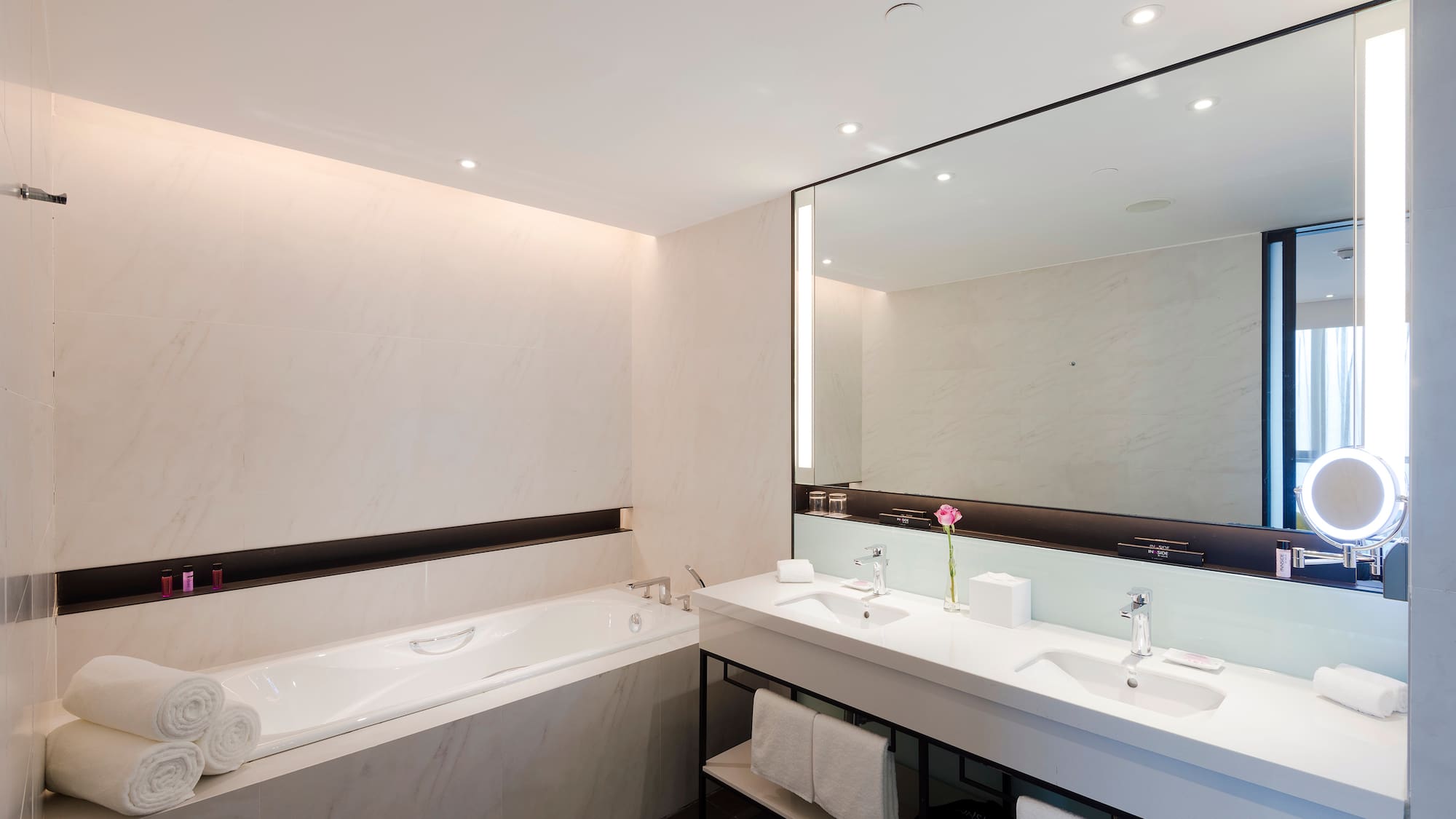 a bathroom with a large mirror and a tub