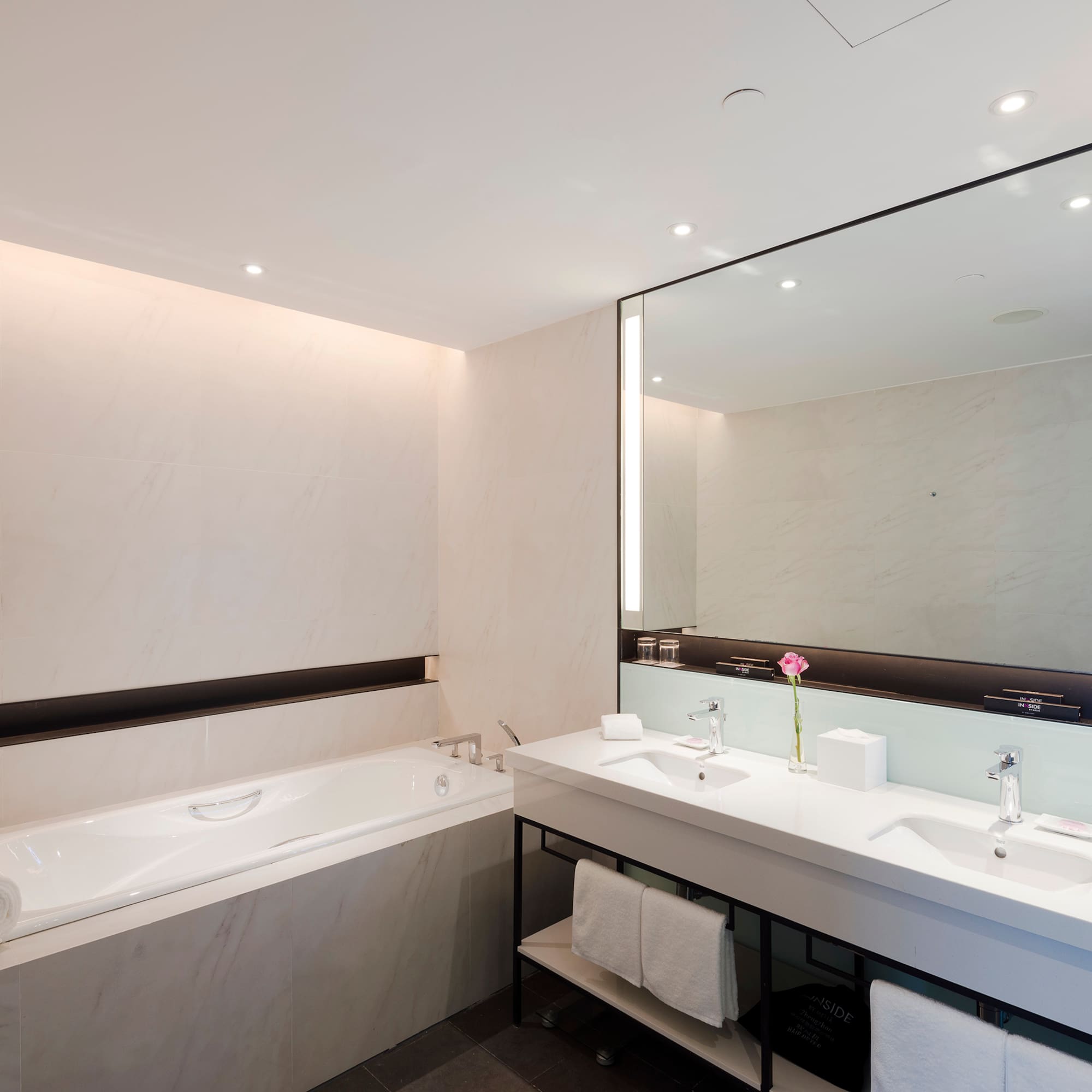 a bathroom with a large mirror and a tub