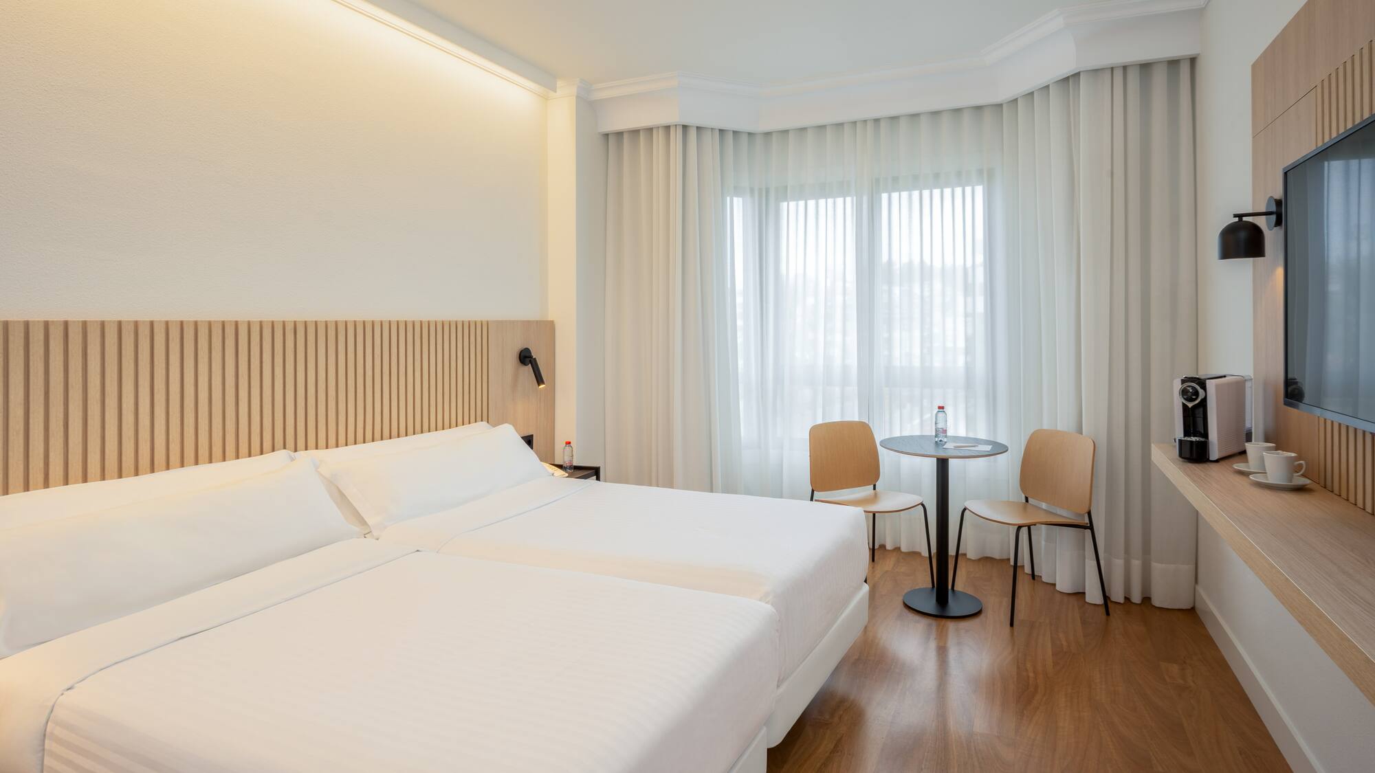 a room with two beds and a table