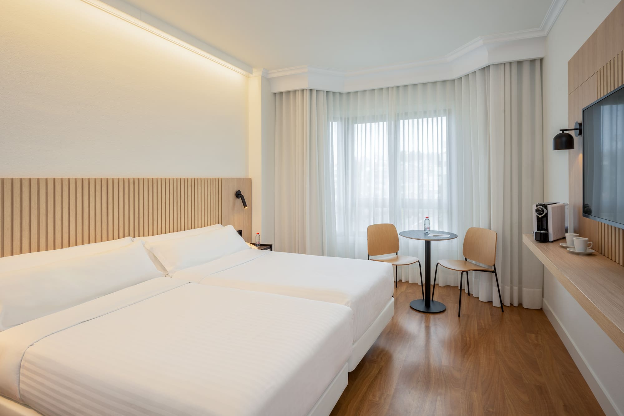 a room with two beds and a table