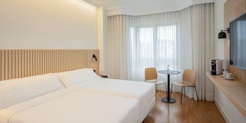 a room with two beds and a table