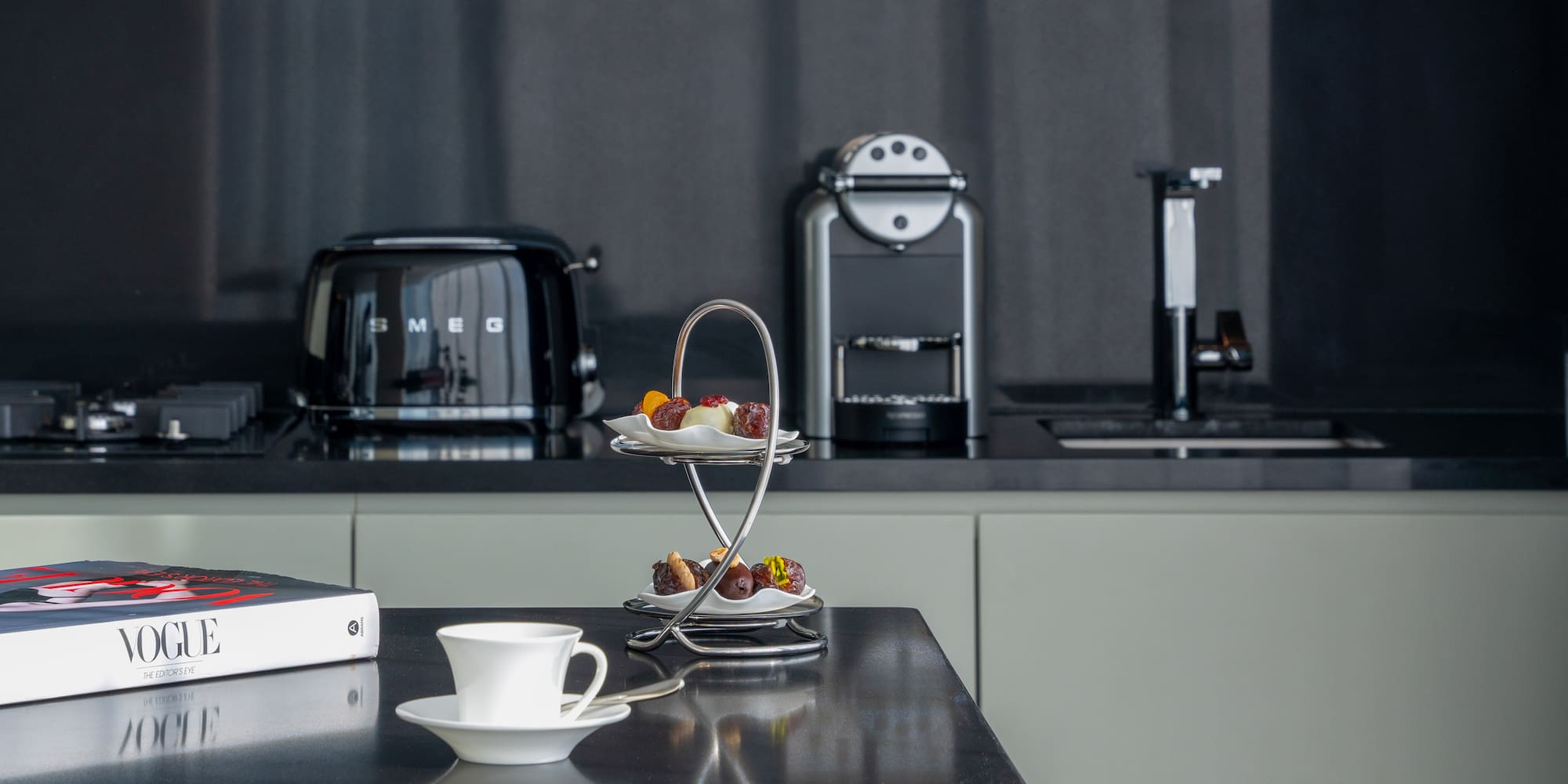 a coffee cup and saucer on a table in a kitchen.