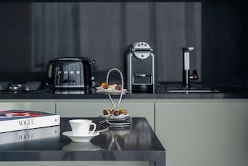 a coffee cup and saucer on a table in a kitchen.