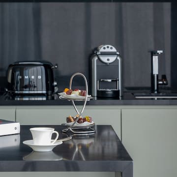 a coffee cup and saucer on a table in a kitchen