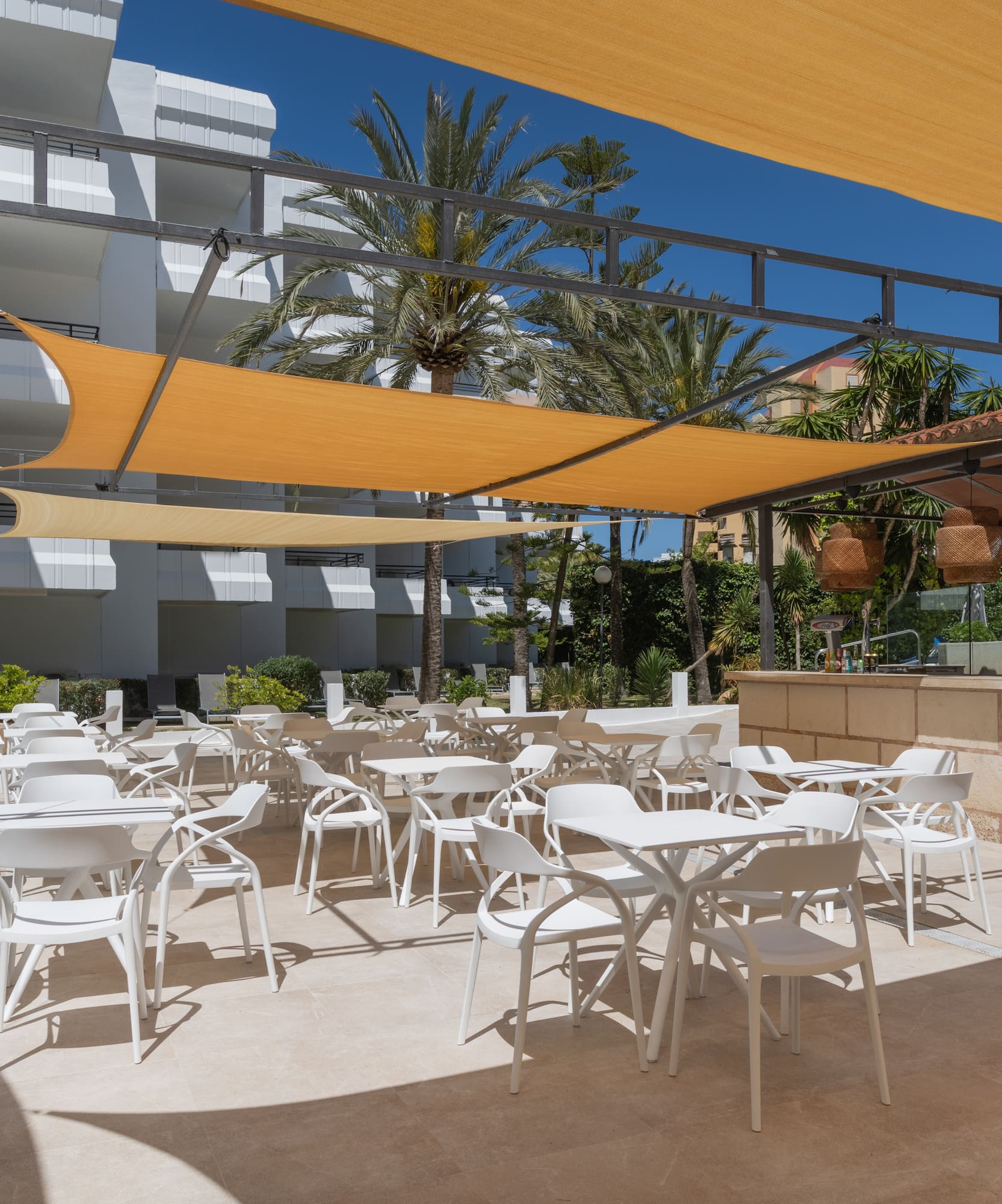 a patio with tables and chairs