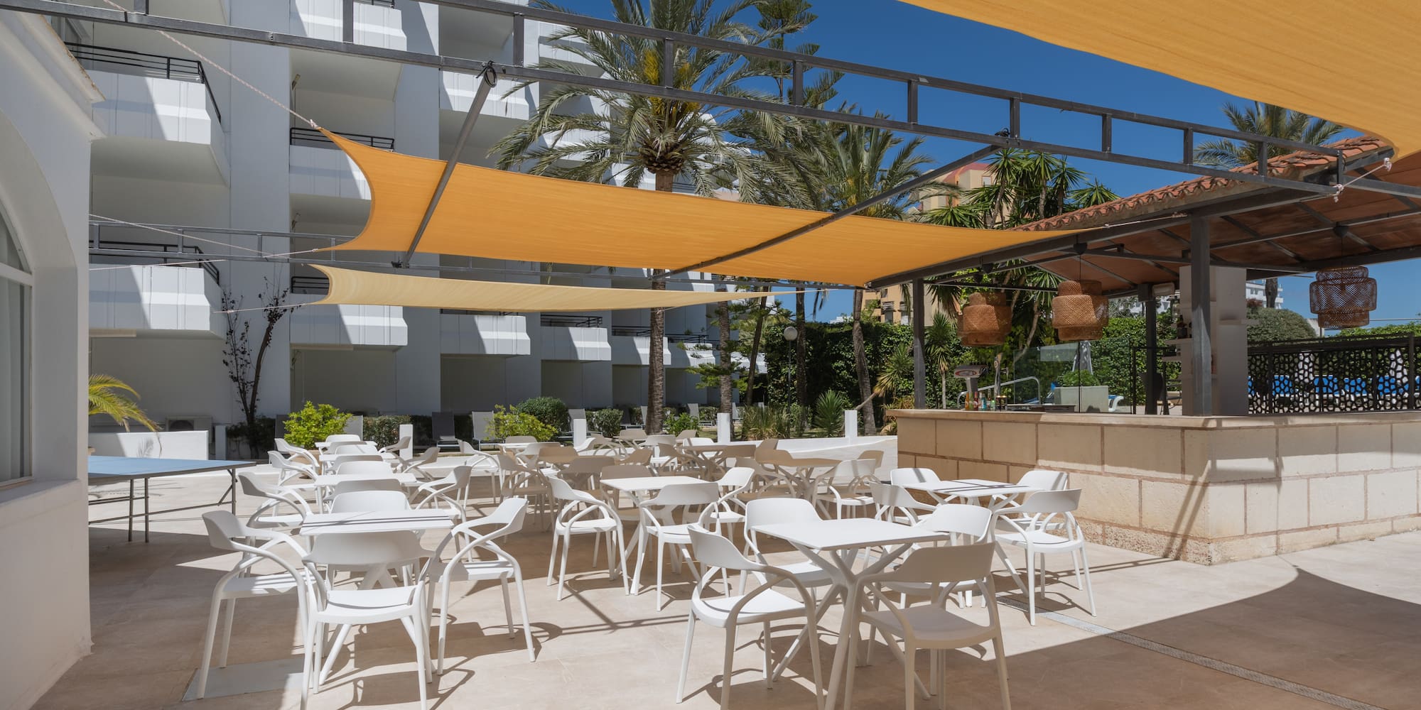 a patio with tables and chairs