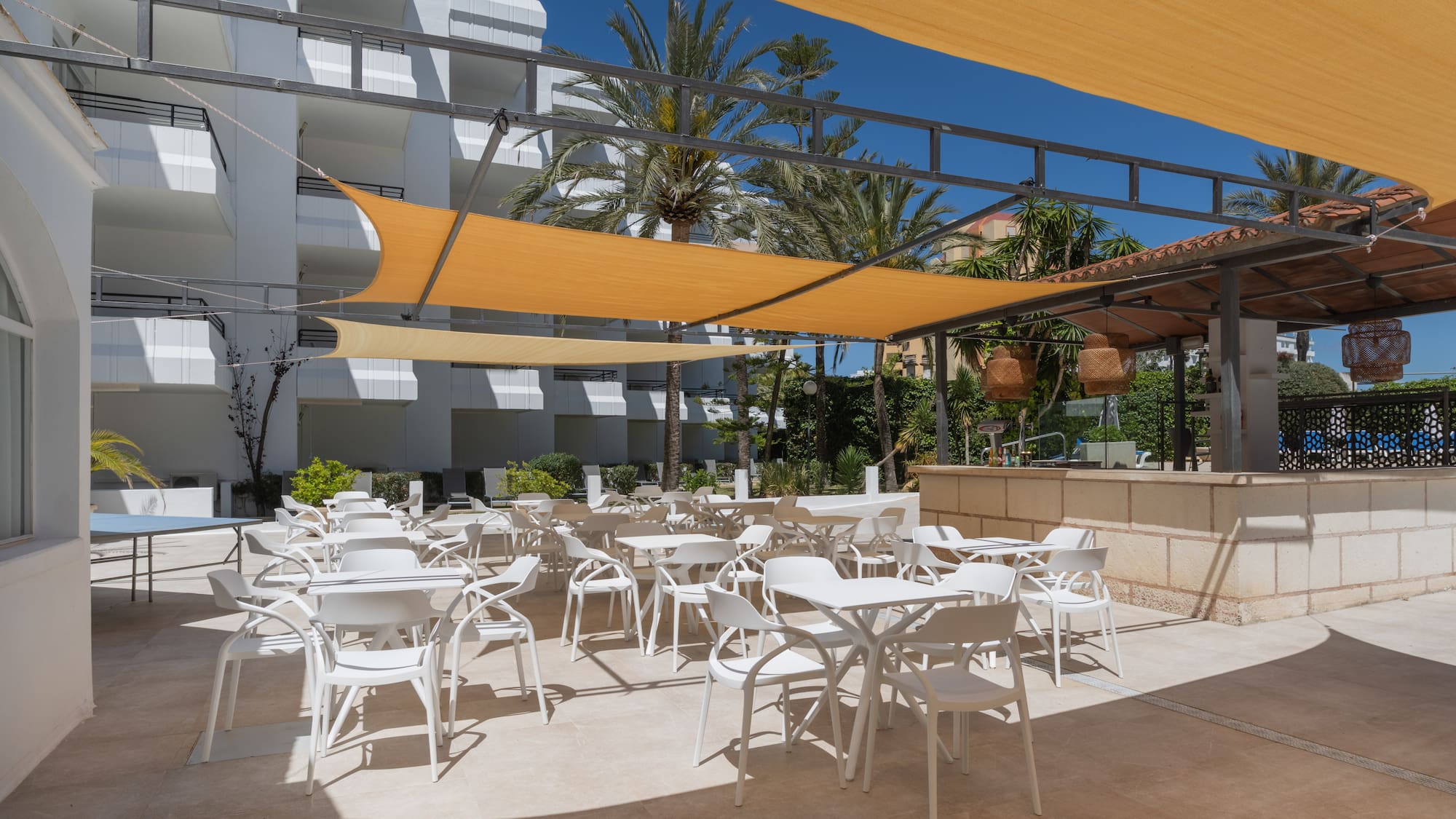 a patio with tables and chairs