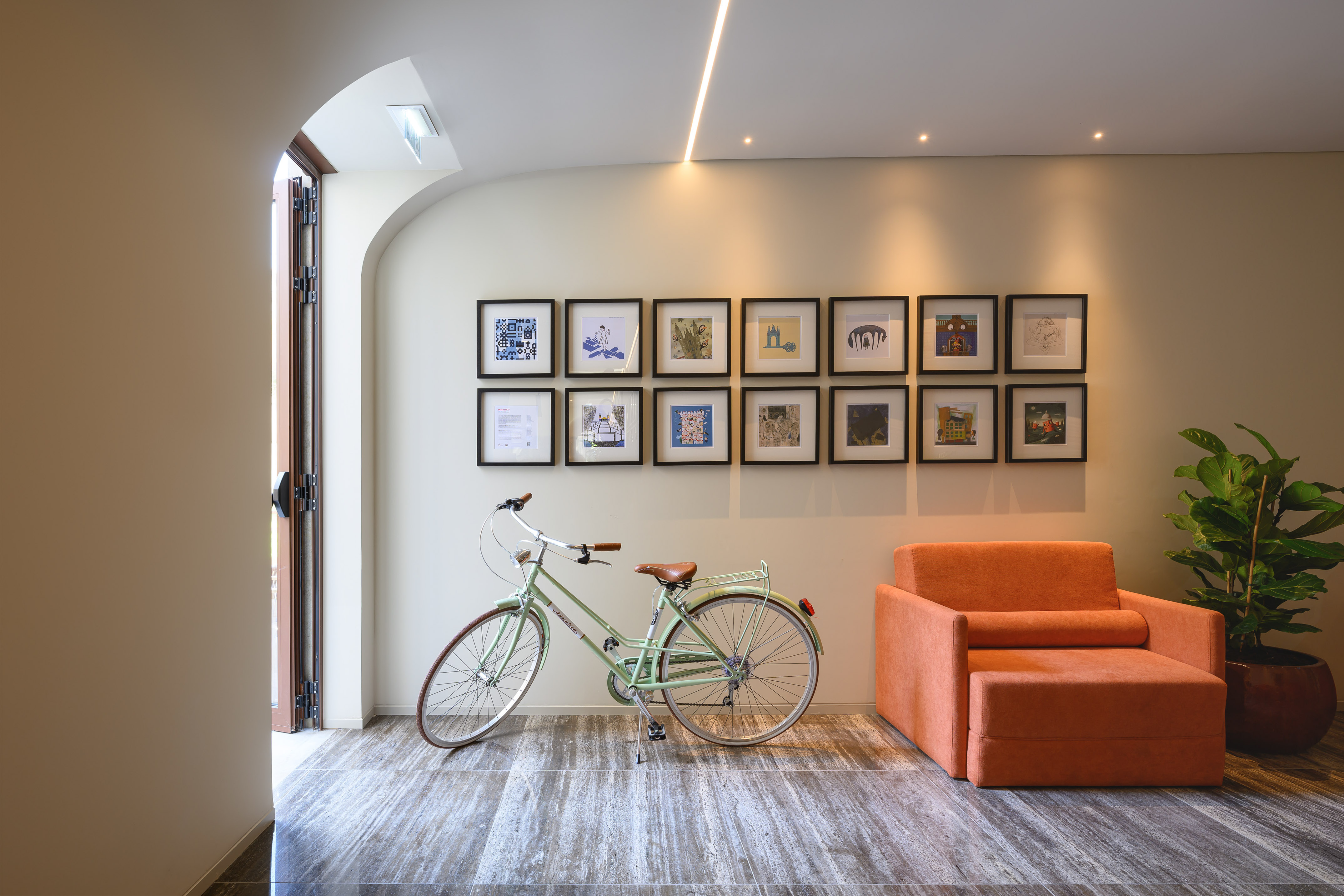 Vintage bicycle, orange armchair, gallery wall, modern arched entryway. - INNSiDE Braga Centro, 브라가
