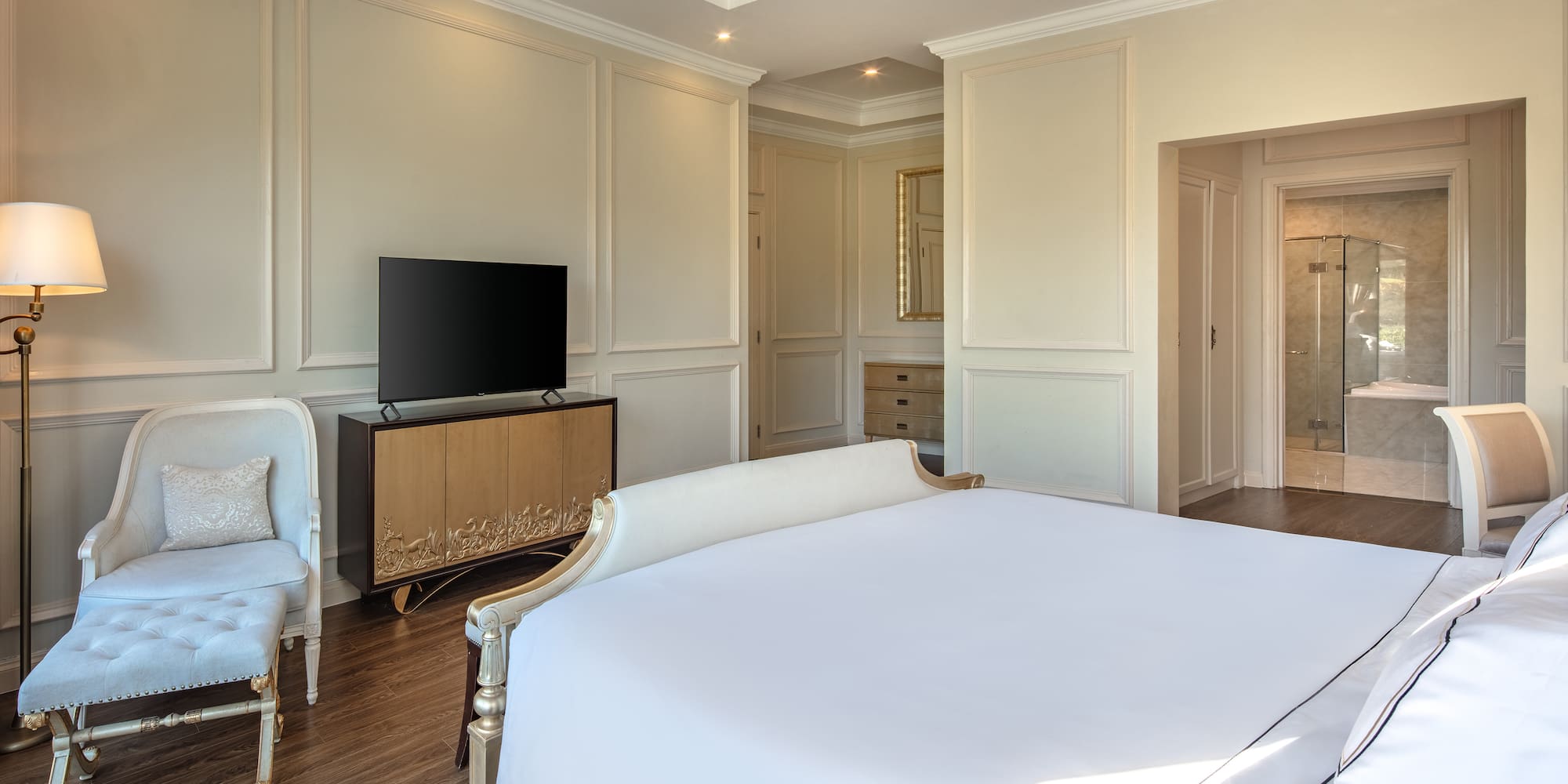 a bedroom with a bed and a television