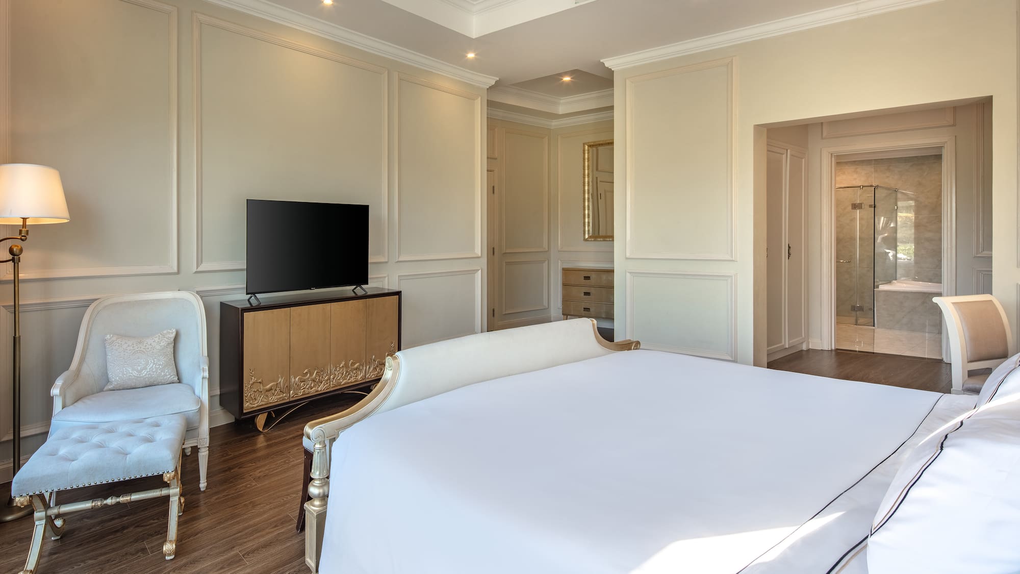 a bedroom with a bed and a television