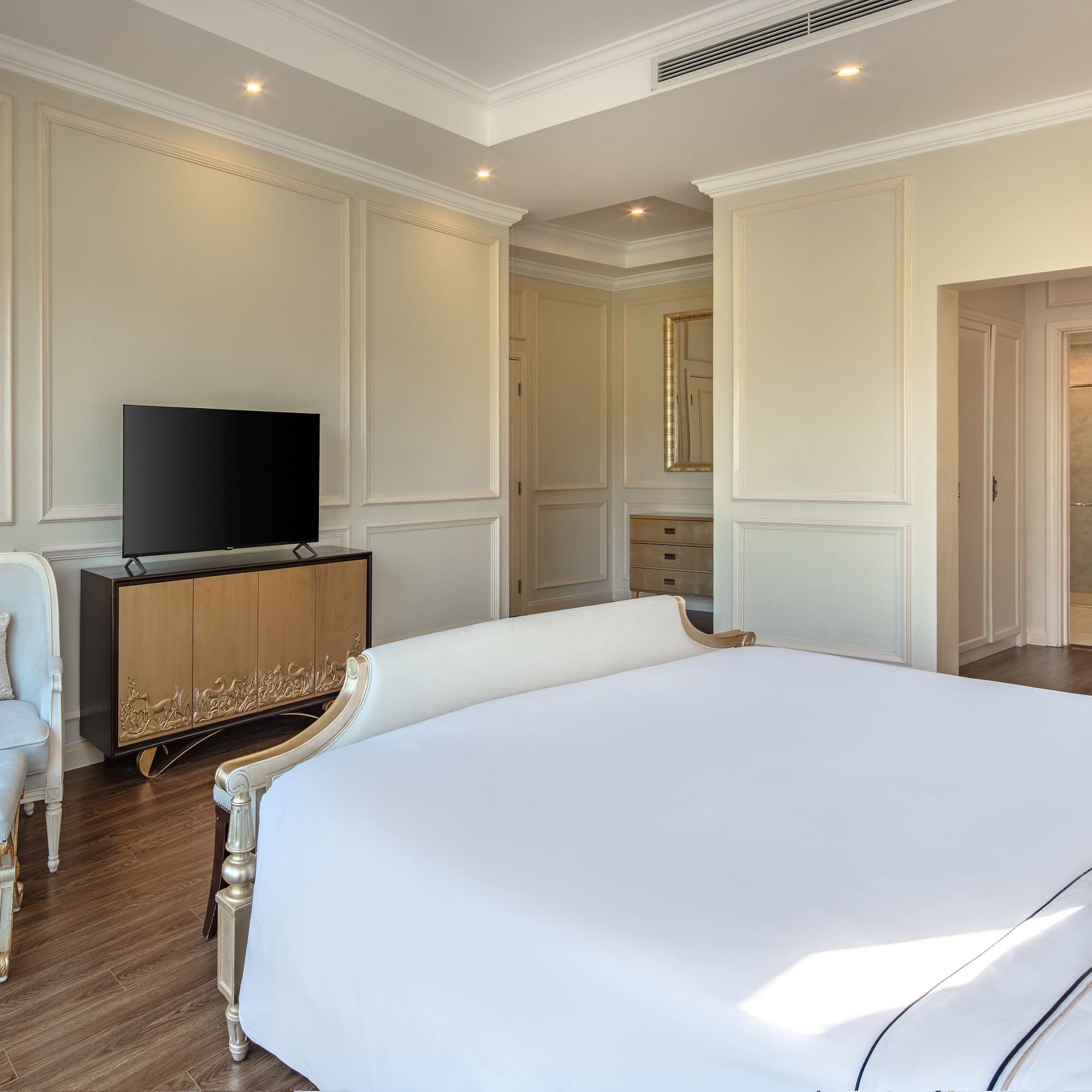 a bedroom with a bed and a television