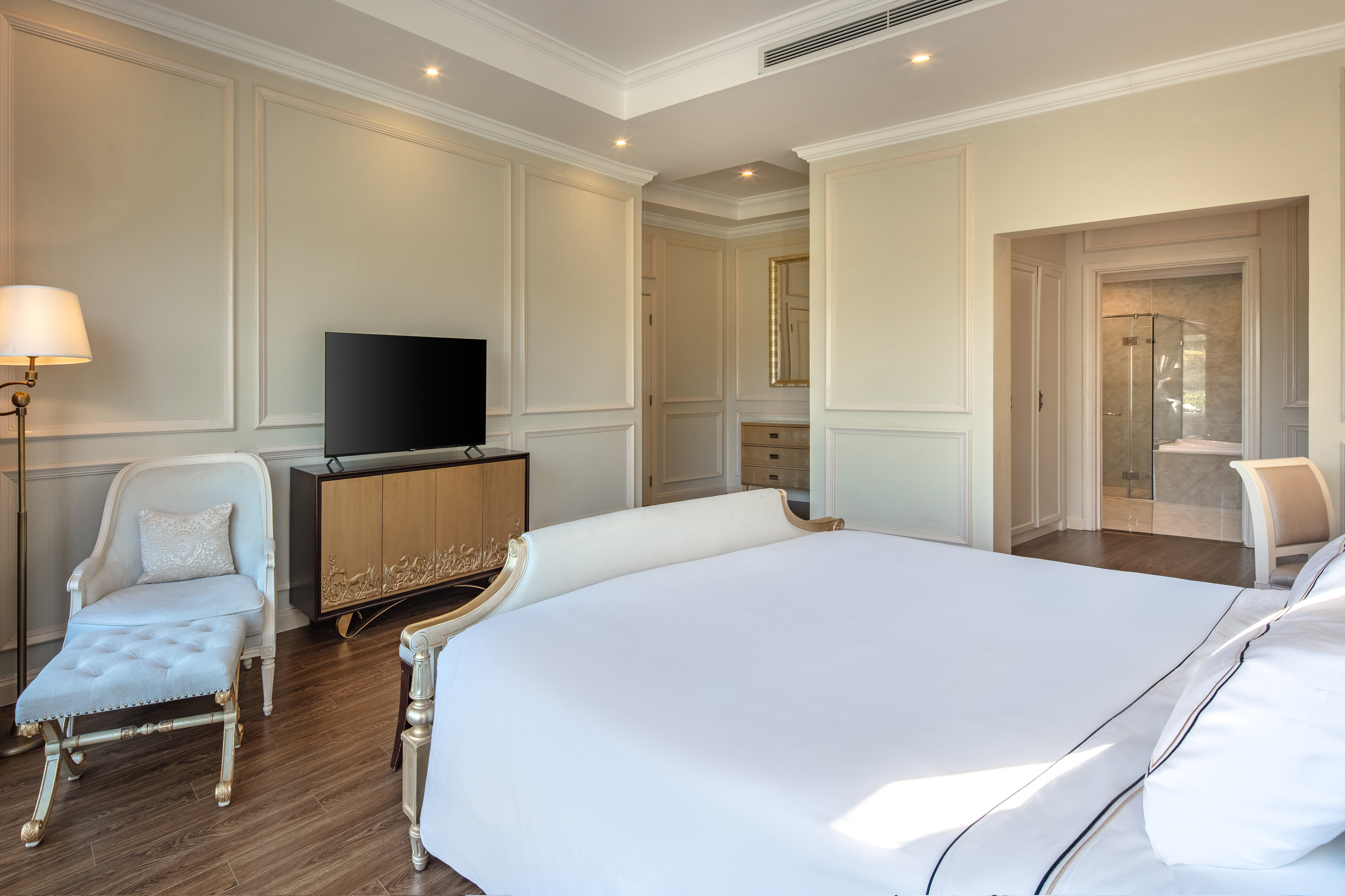 a bedroom with a bed and a television