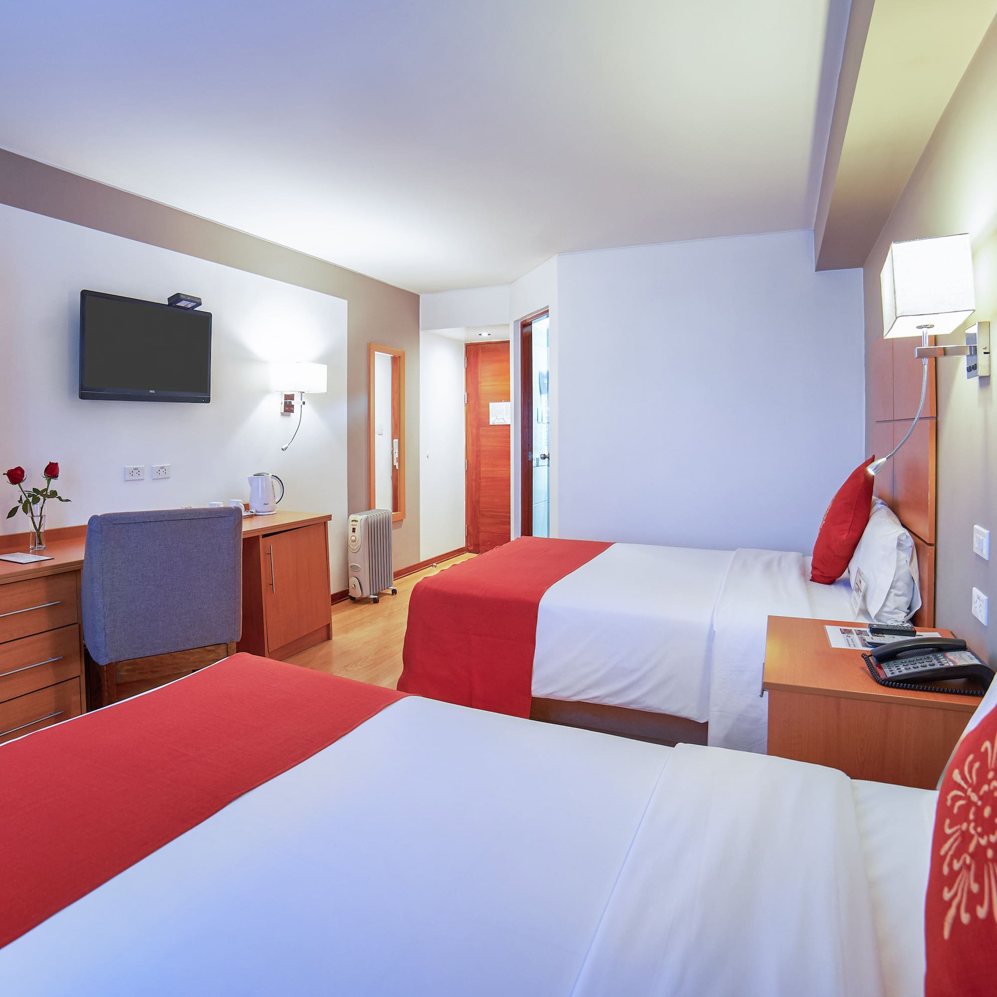 a room with two beds and a tv
