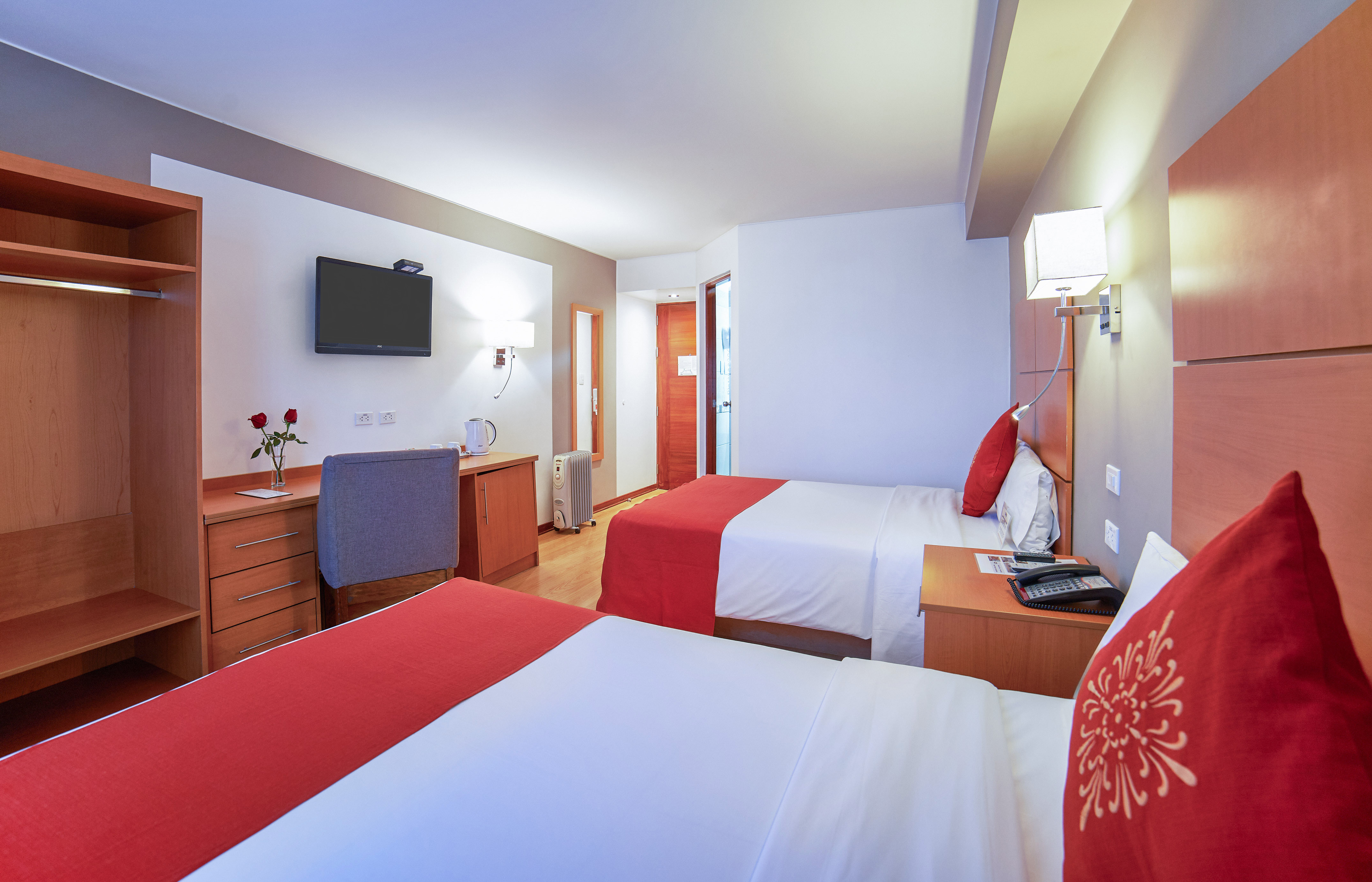 a room with two beds and a tv