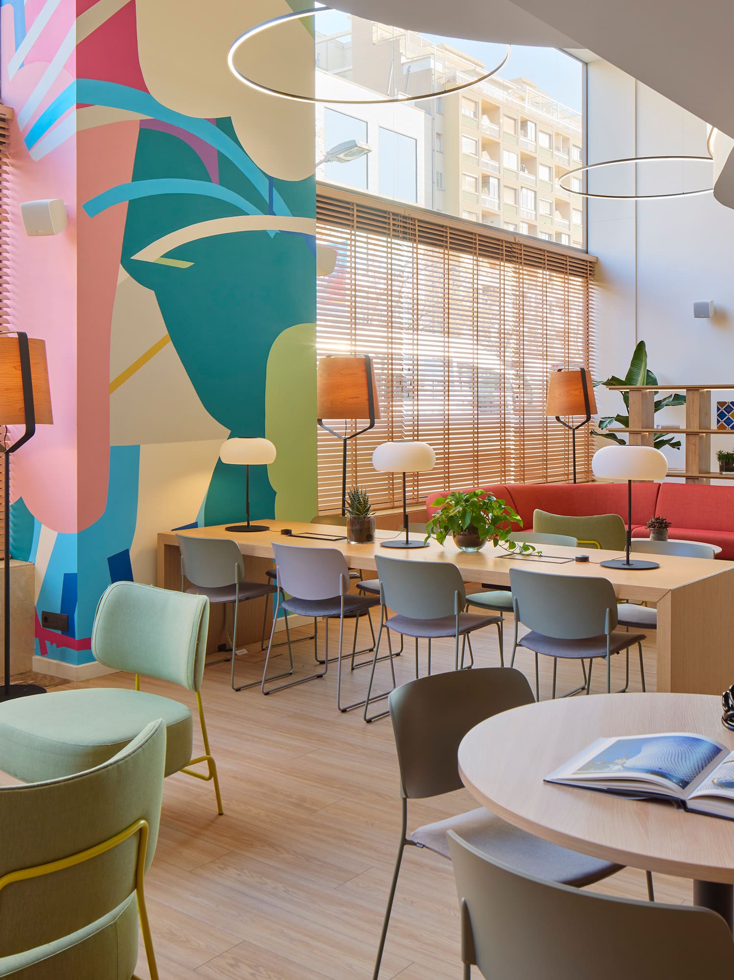 a room with colorful walls and tables and chairs