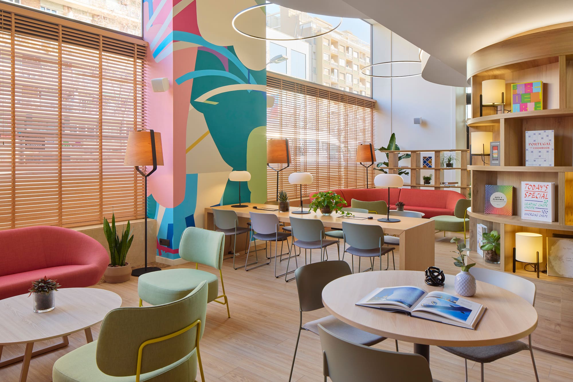 a room with colorful walls and tables and chairs