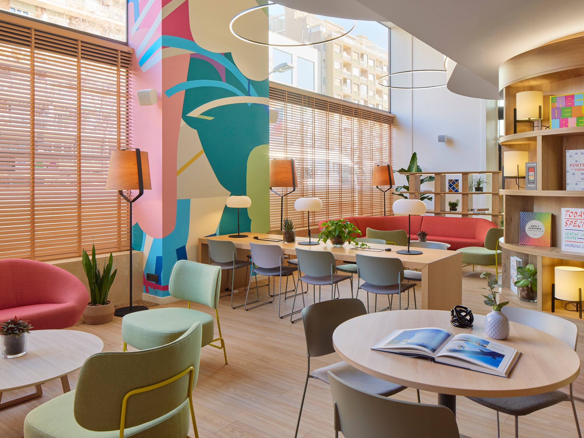 a room with colorful walls and tables and chairs