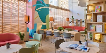 a room with colorful walls and tables and chairs