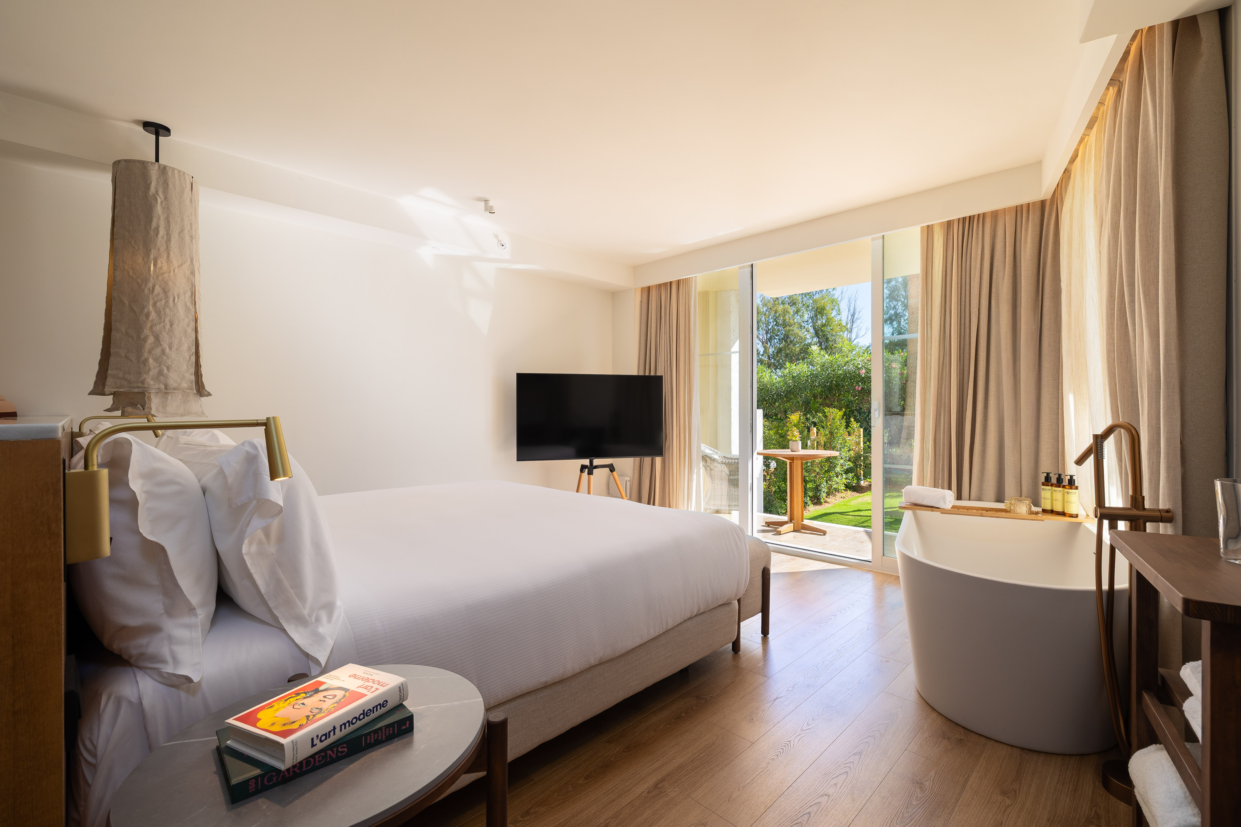 a bedroom with a television and a tub