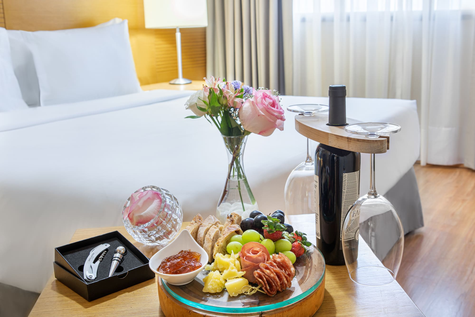 a plate of food on a table with wine glasses and a bottle of wine