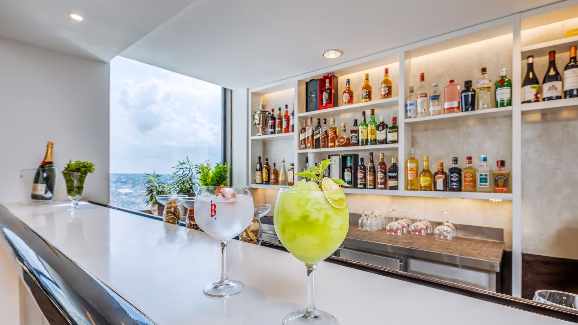 a two glasses of drinks on a bar