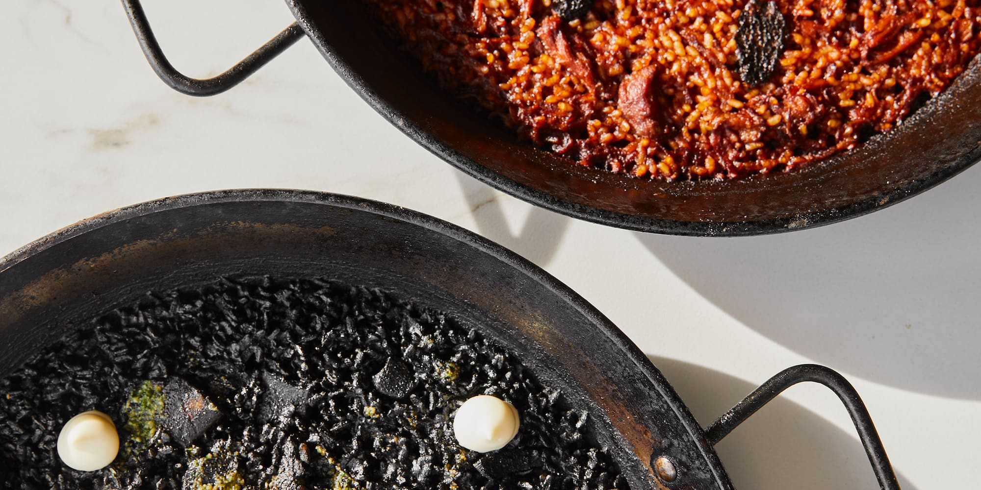 two black pans with food on them