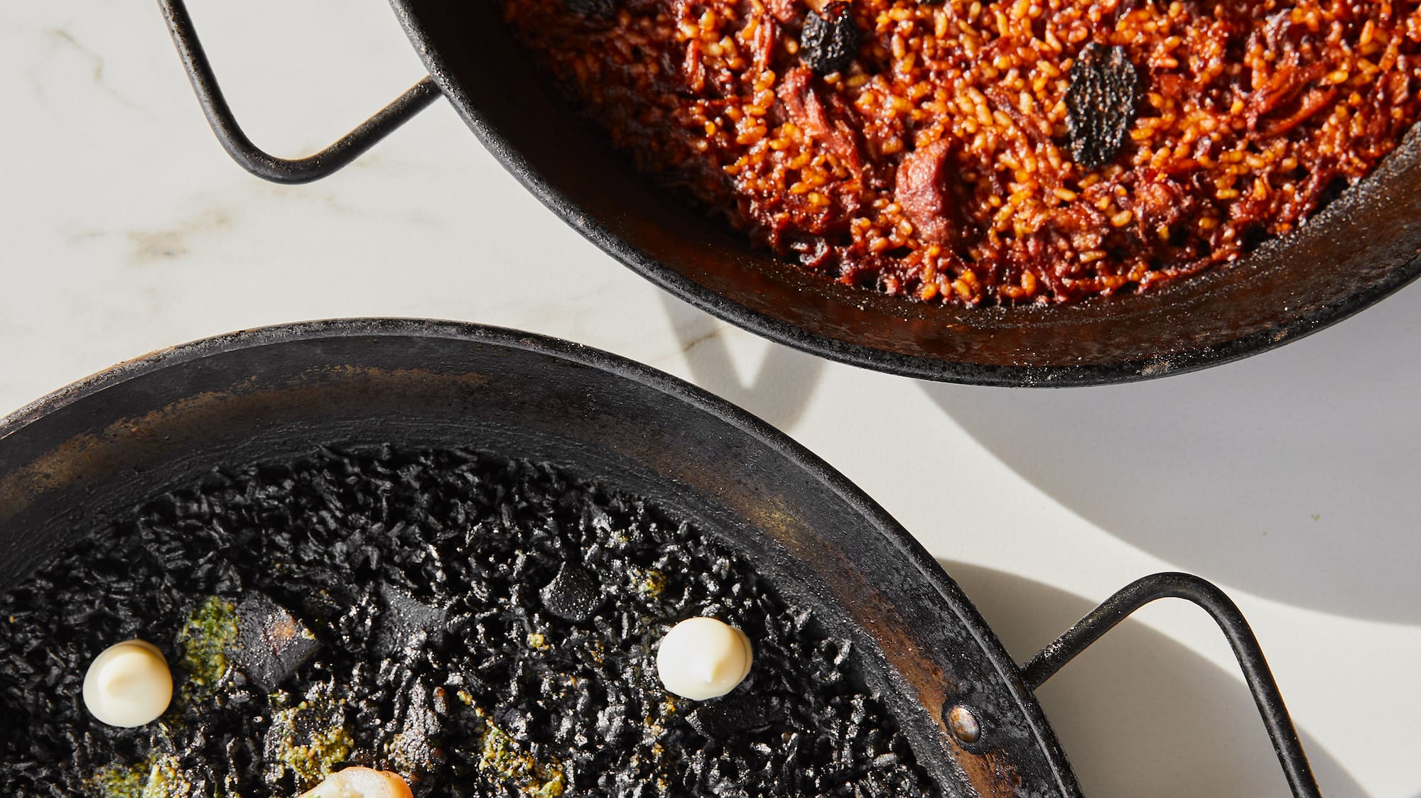 two black pans with food on them