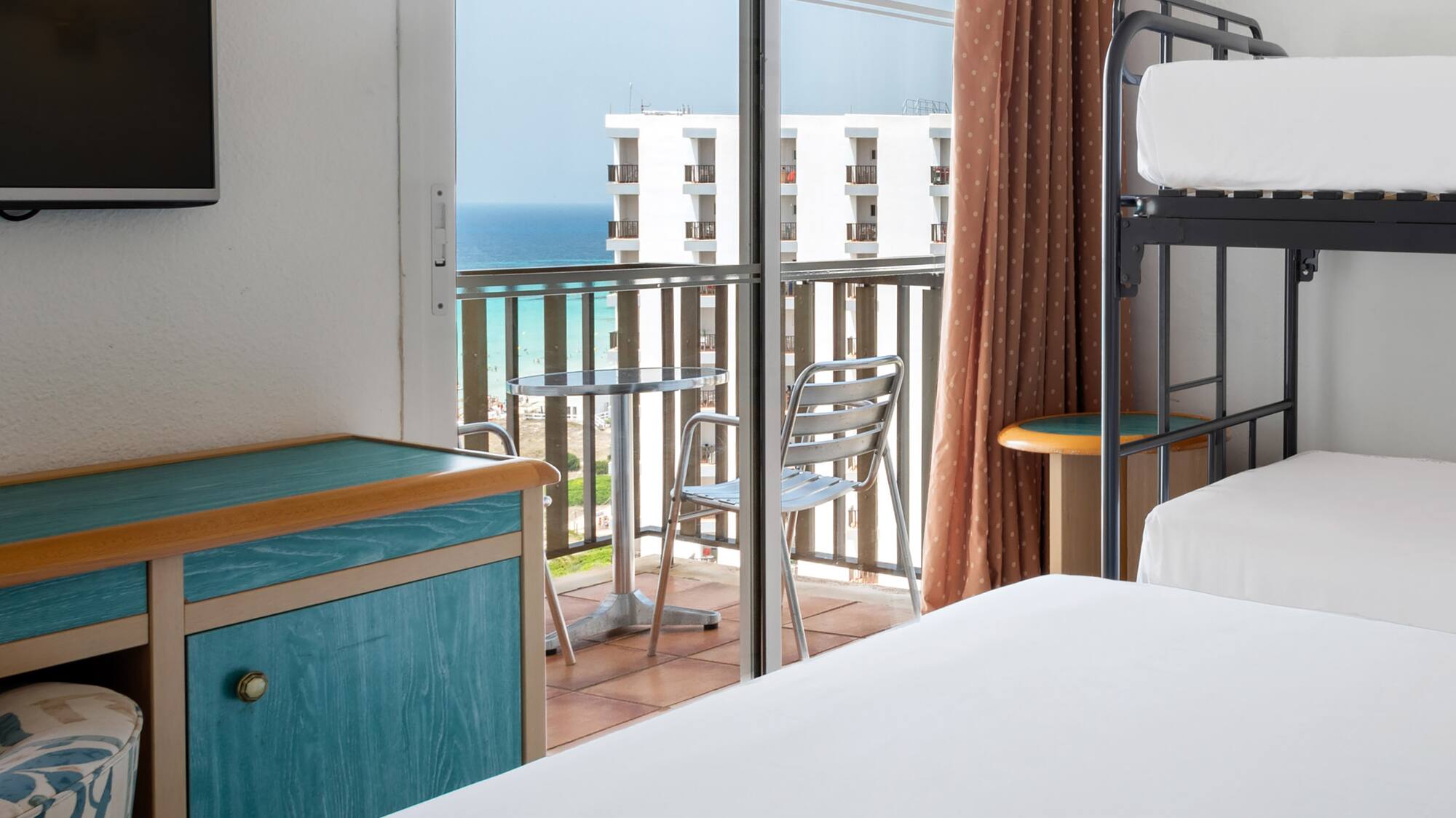 a room with a balcony and a television