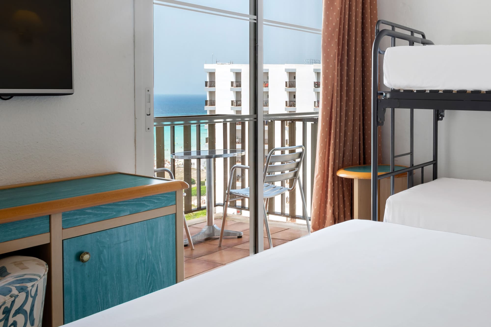 a room with a balcony and a television