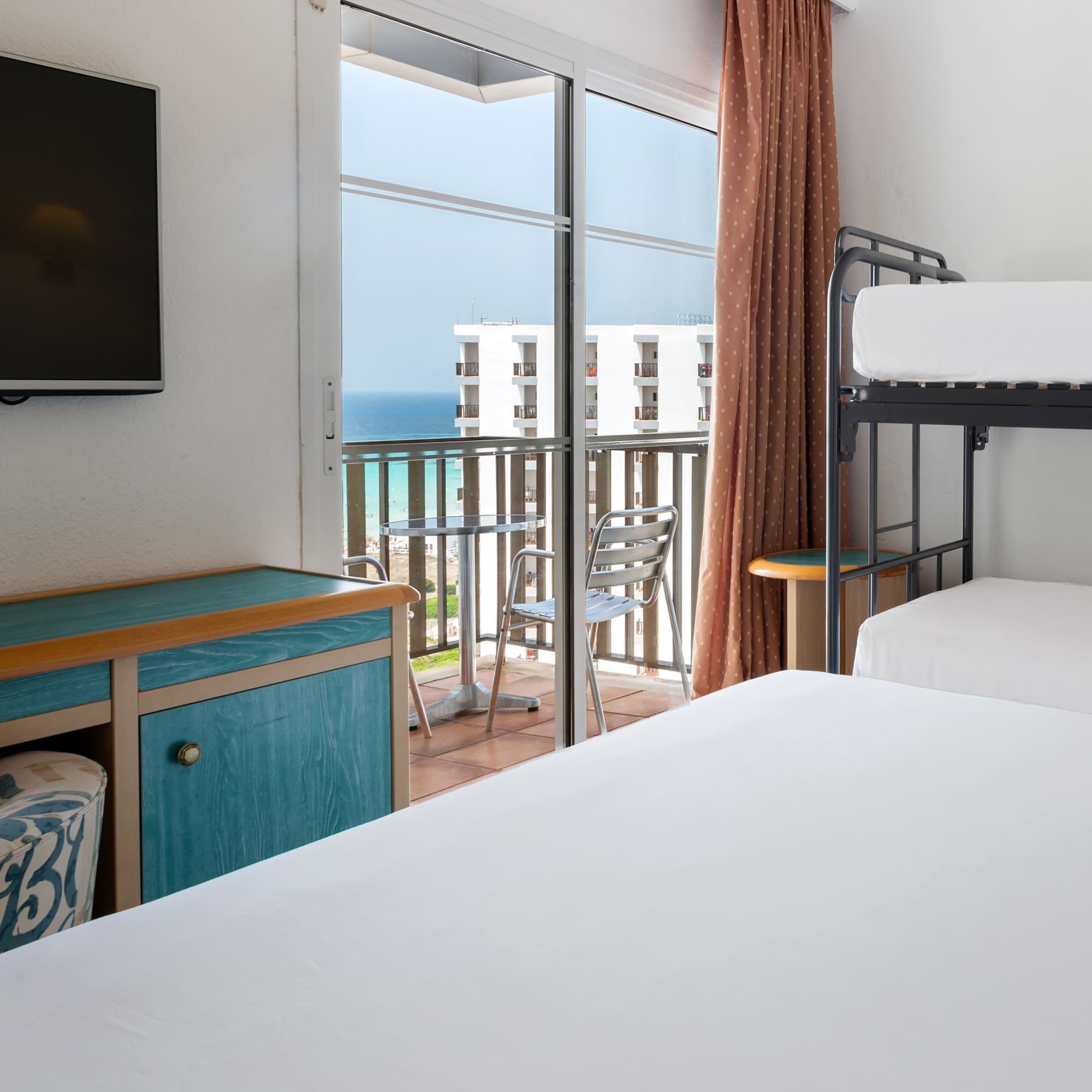 a room with a balcony and a television