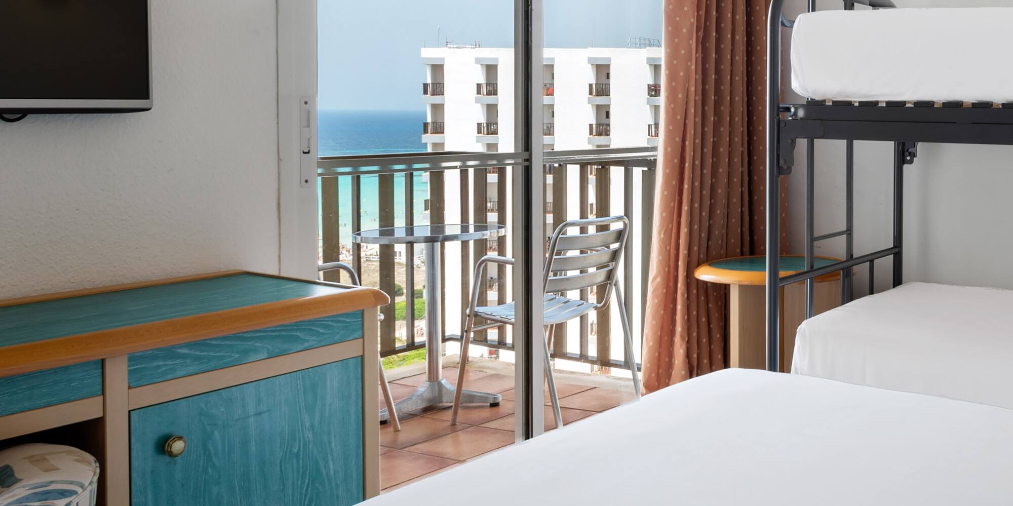 a room with a balcony and a television