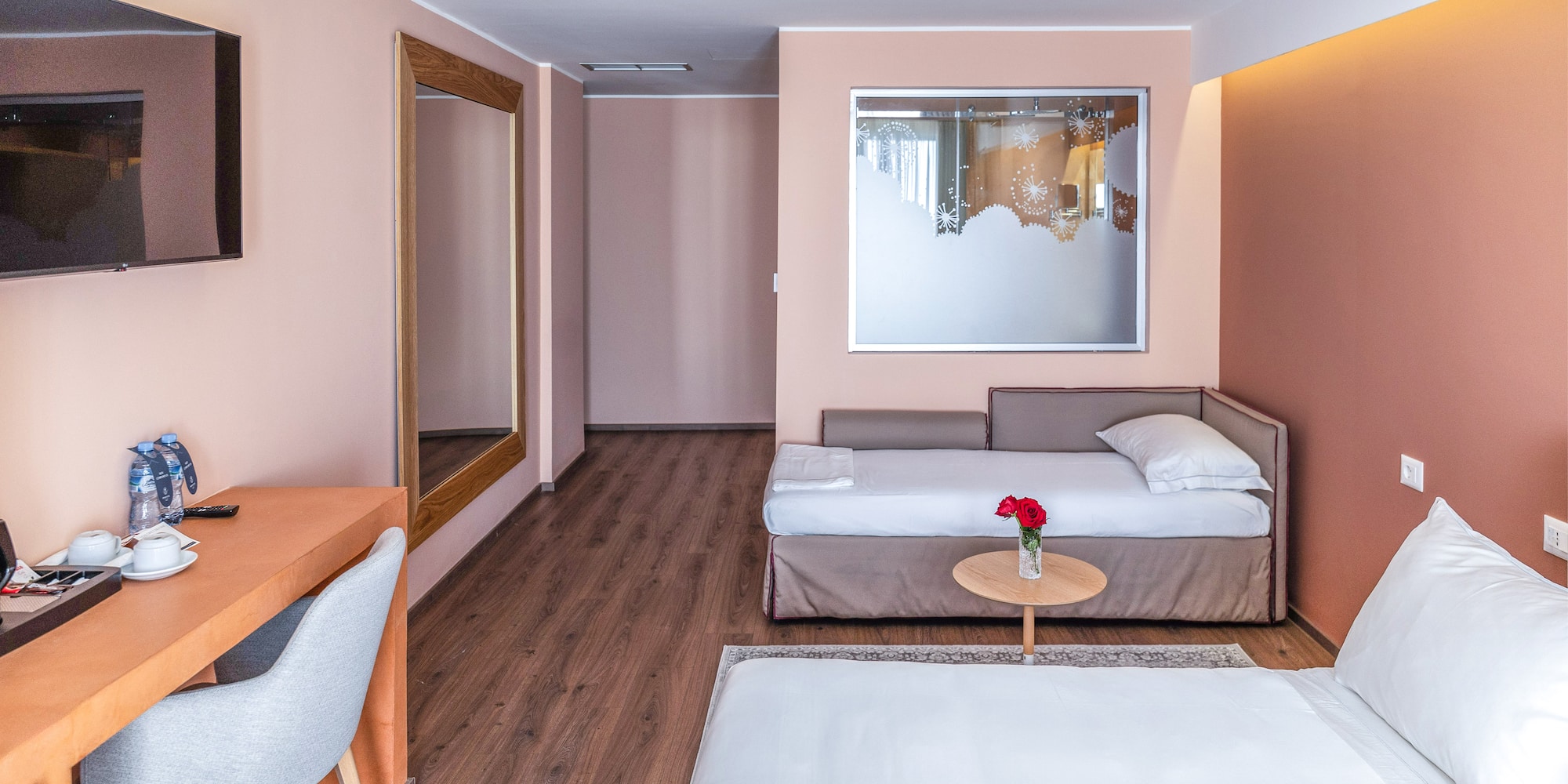 a room with a bed and a mirror