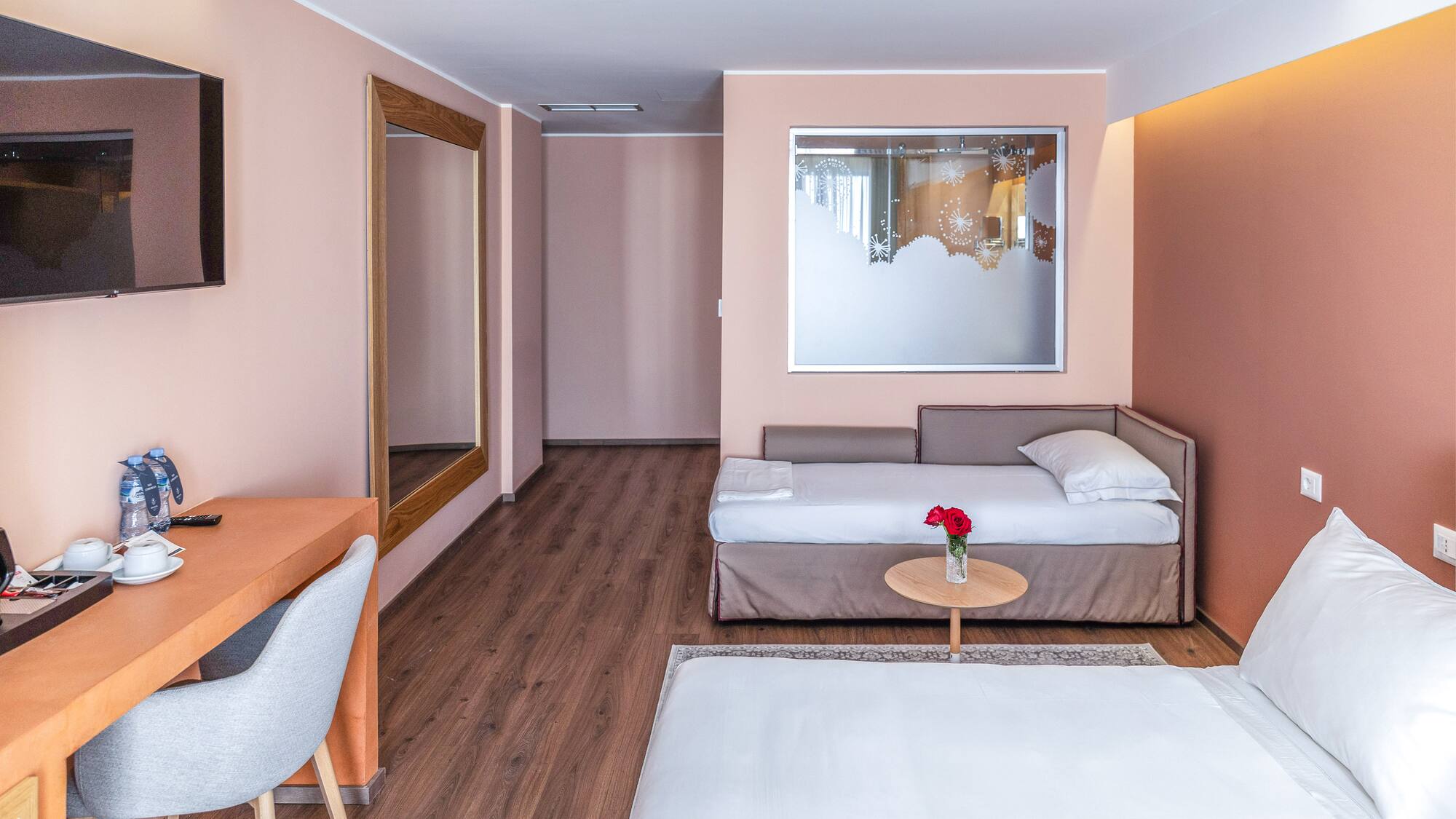 a room with a bed and a mirror