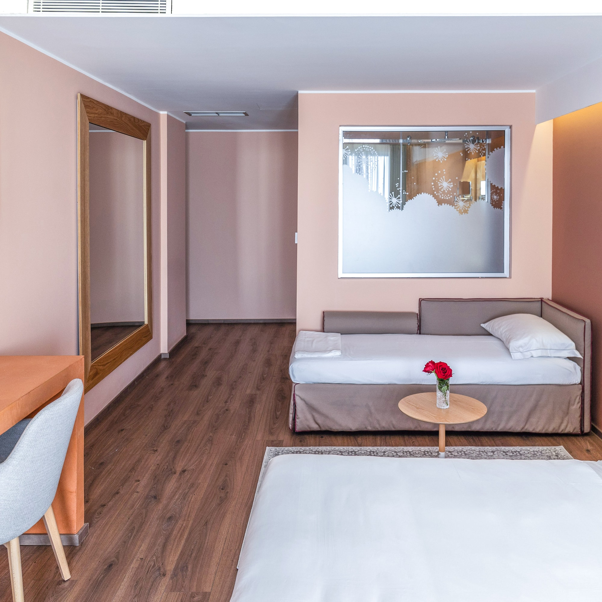 a room with a bed and a mirror