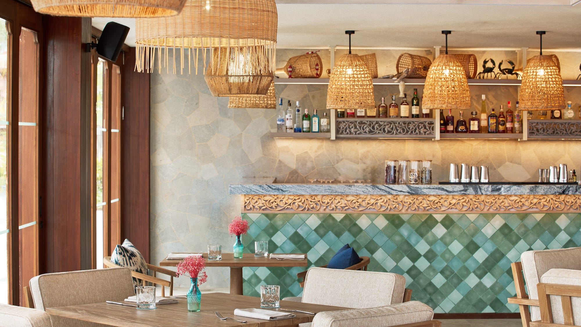 a restaurant with wicker chairs and tables