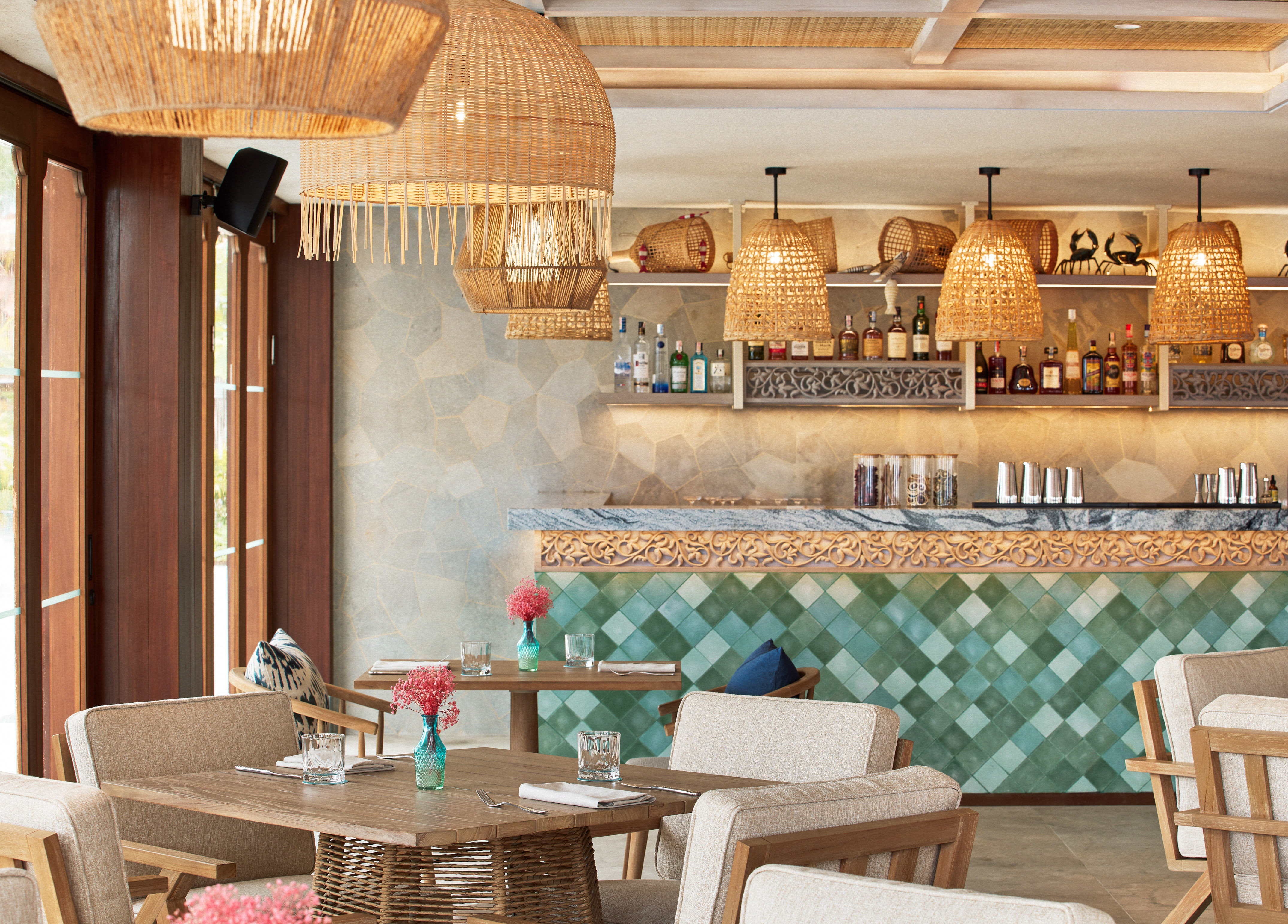 a restaurant with wicker chairs and tables