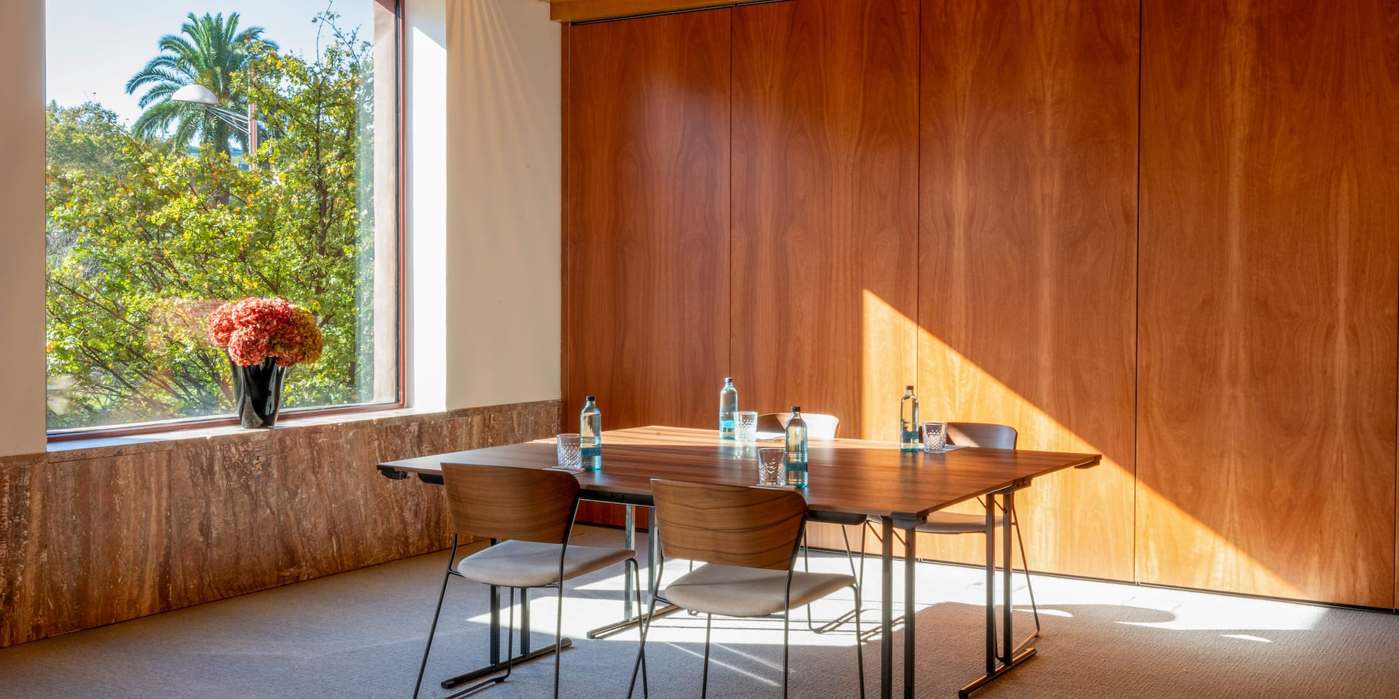 a table and chairs in a room with a window