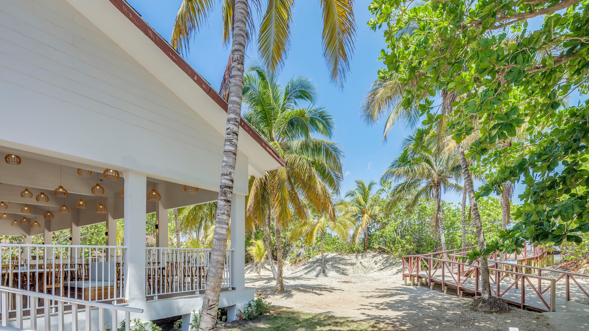 a building with palm trees and a walkway