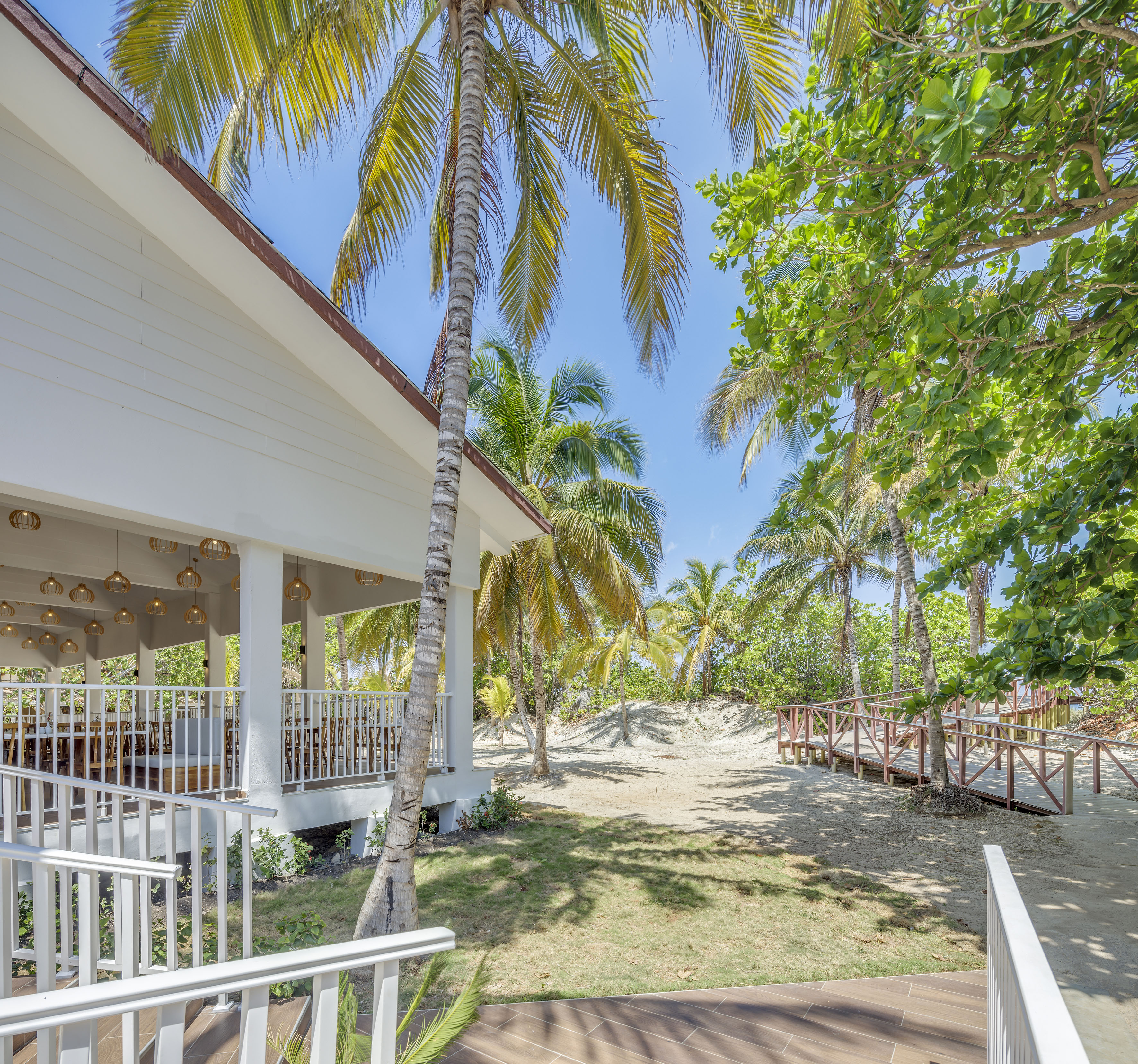 a building with palm trees and a walkway