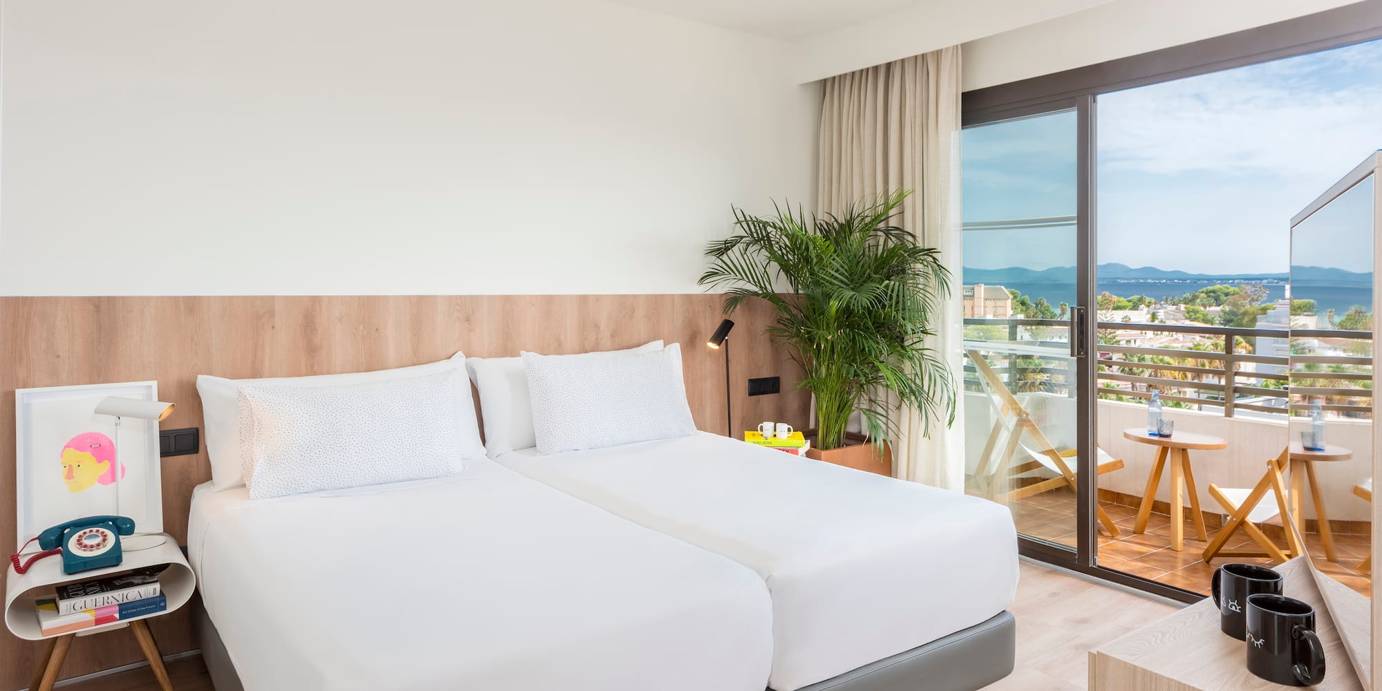 a room with two beds and a glass door