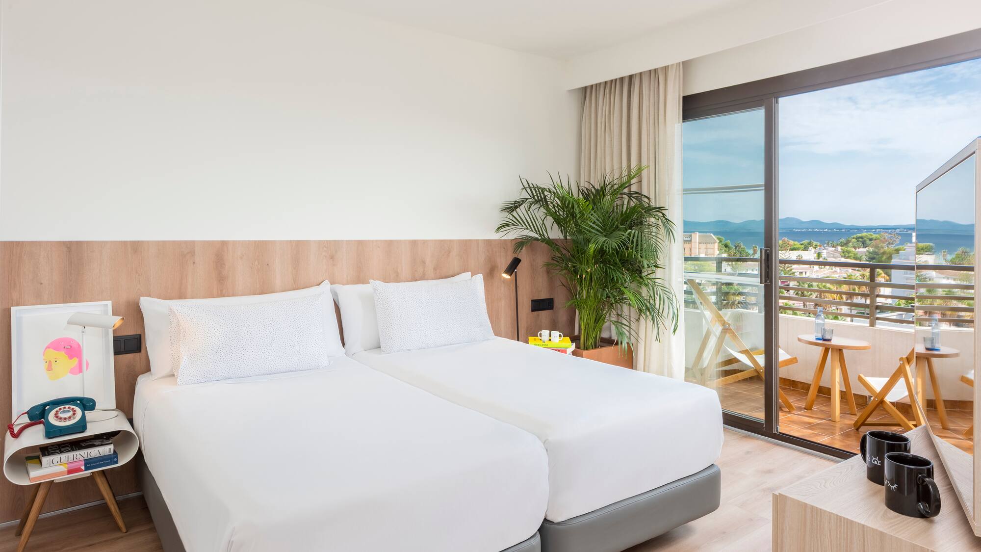 a room with two beds and a glass door