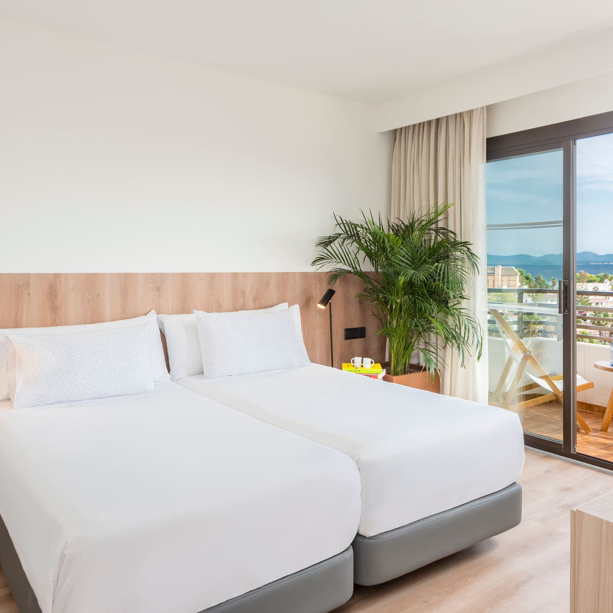 a room with two beds and a glass door