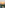 Tropical resort villas with palm trees and lakes, ocean sunset aerial view.