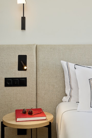 a bed with a light on the wall