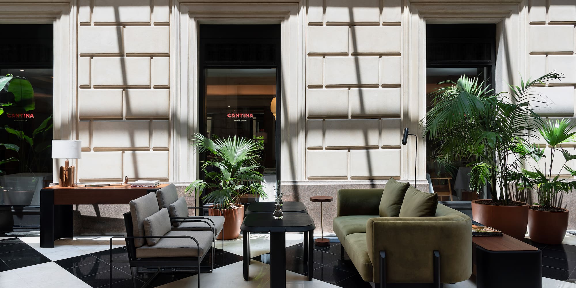 a room with a black and white checkered floor and a couch and a table