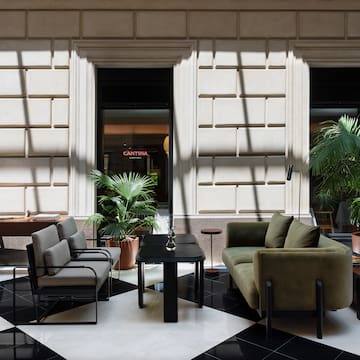 a room with a black and white checkered floor and a couch and a table
