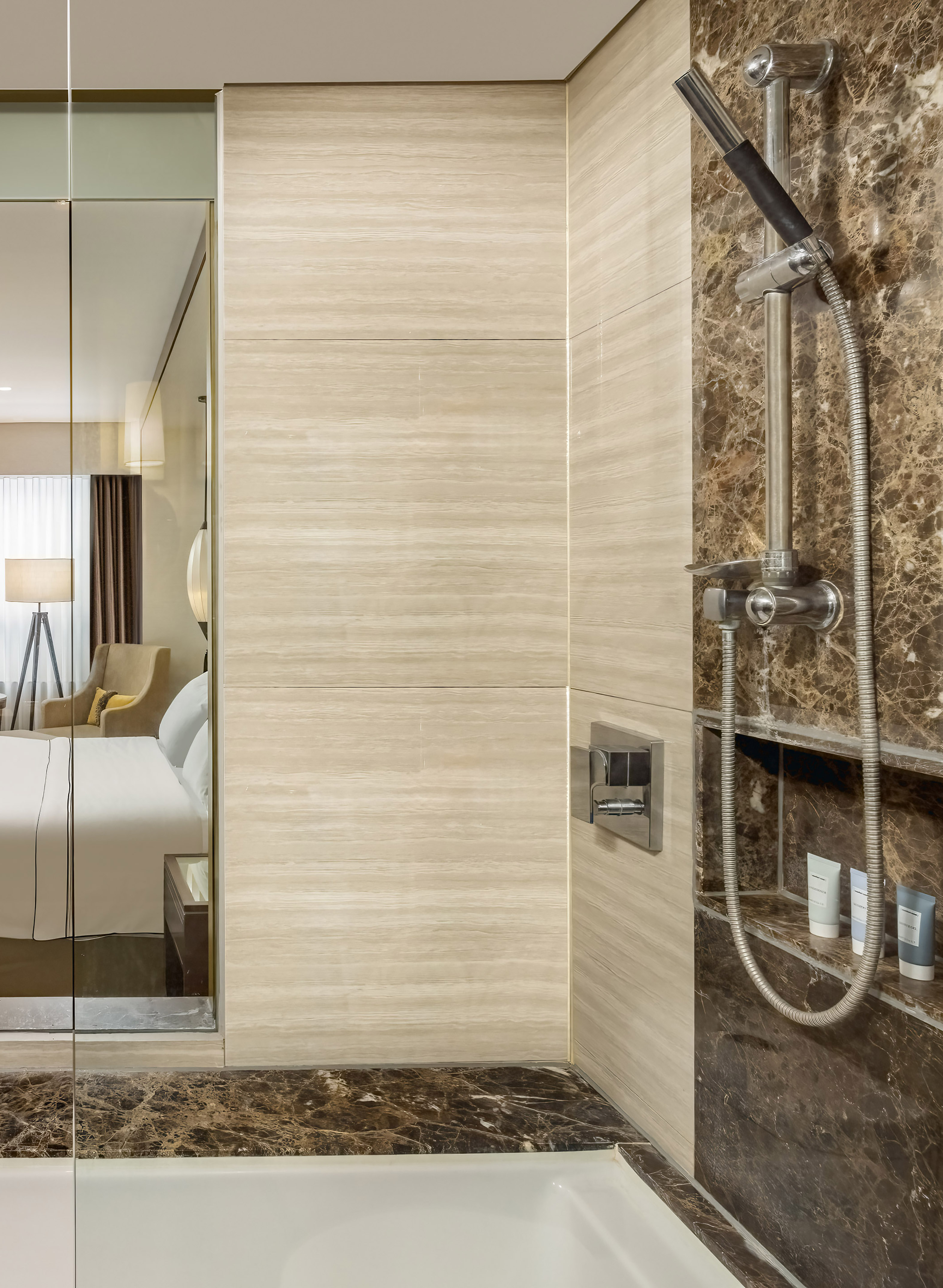 a shower with a shower head and a mirror