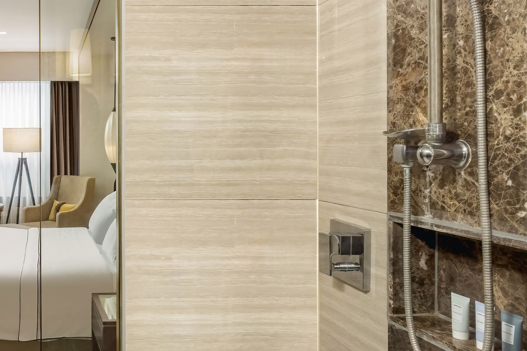 a shower with a shower head and a mirror