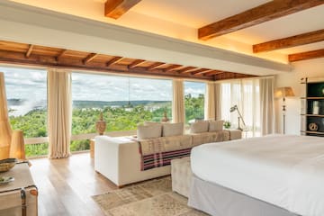 a room with a large bed and a large window