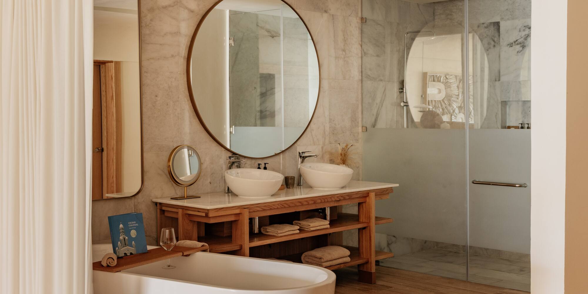 Luxurious modern bathroom with freestanding tub, double vanity, glass shower.